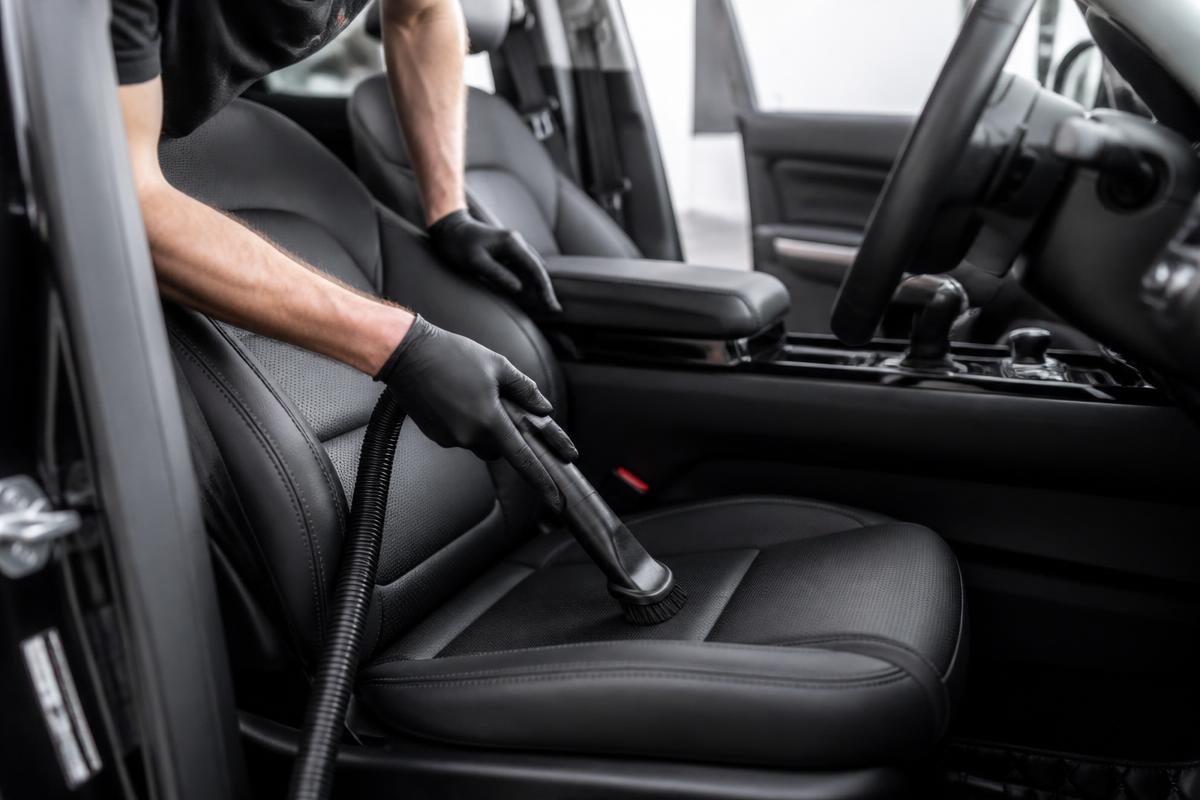 Interior of a car being cleaned with a detailing vacuum